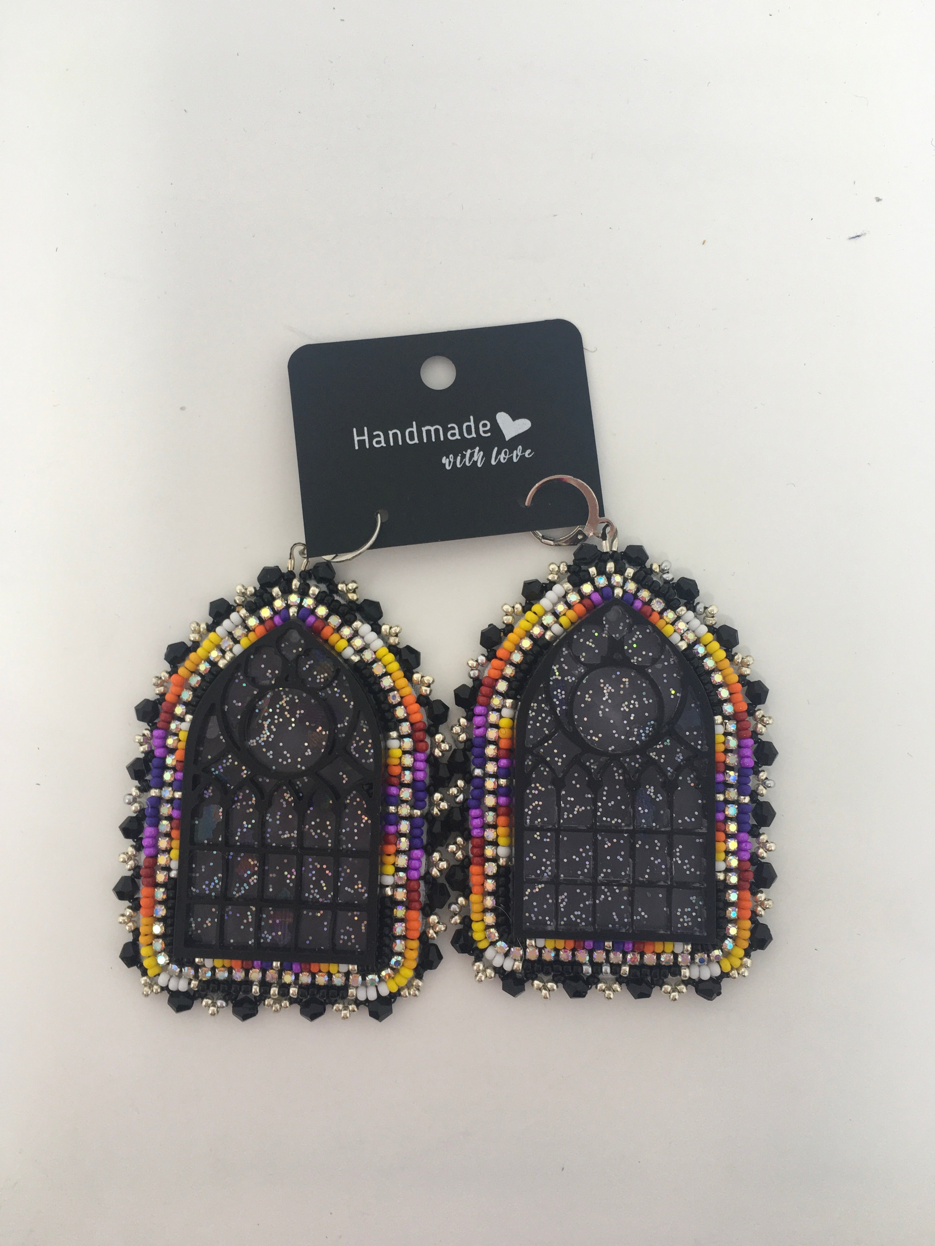 Sunny Poloz cathedral cabochon with purple and fire color beads